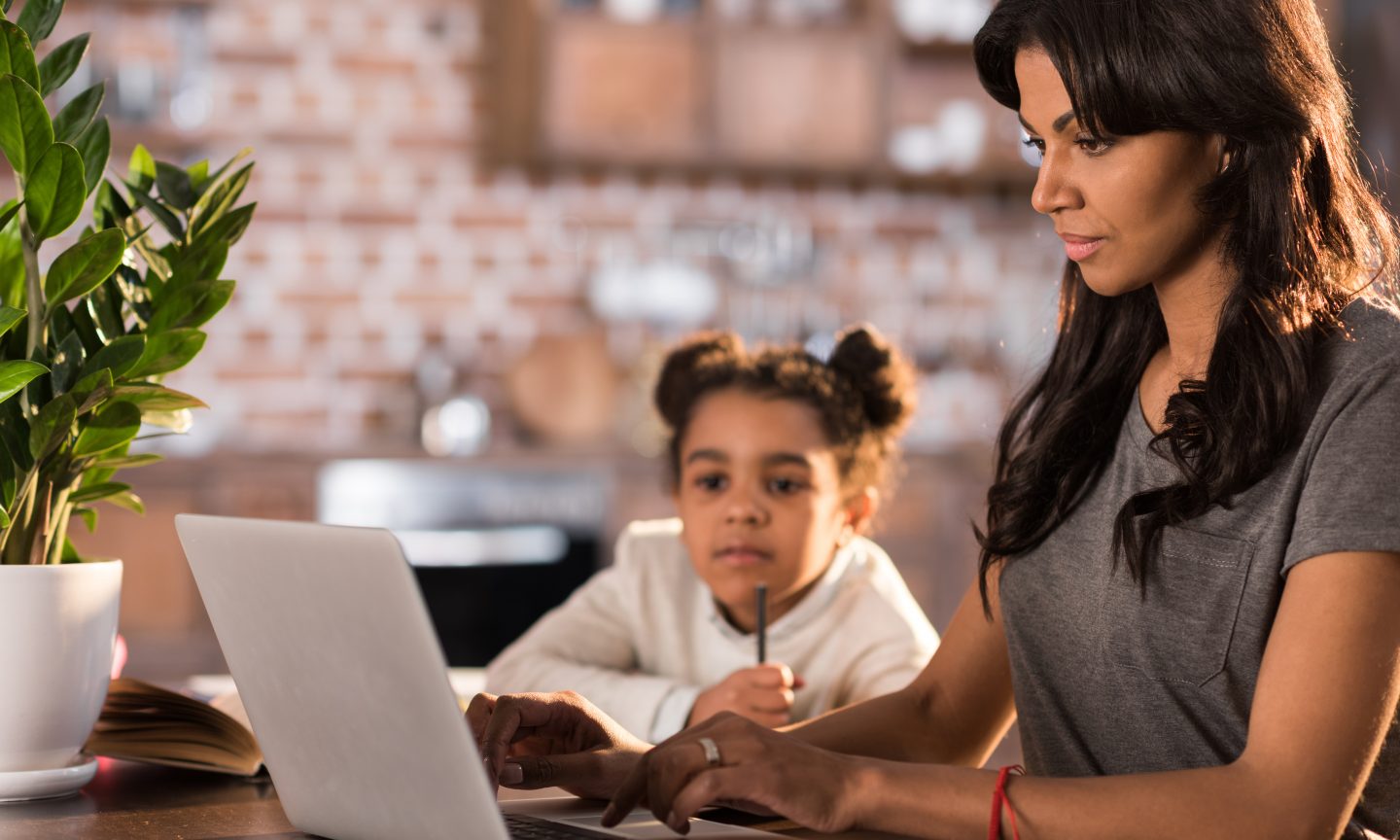 A girl doing her homework with teacher's help.