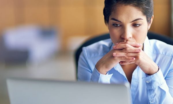 Young woman looks at laptop