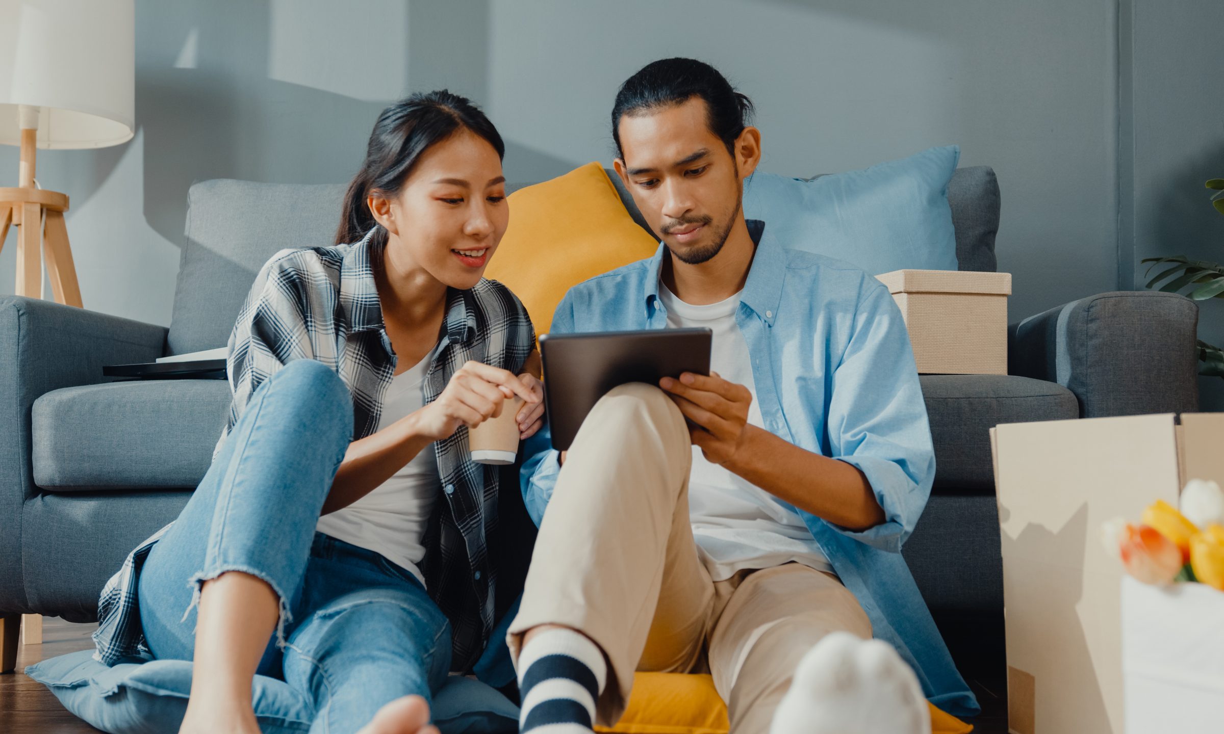 Happy Asian Couple Playing Computer Video Game Sitting On Couch At