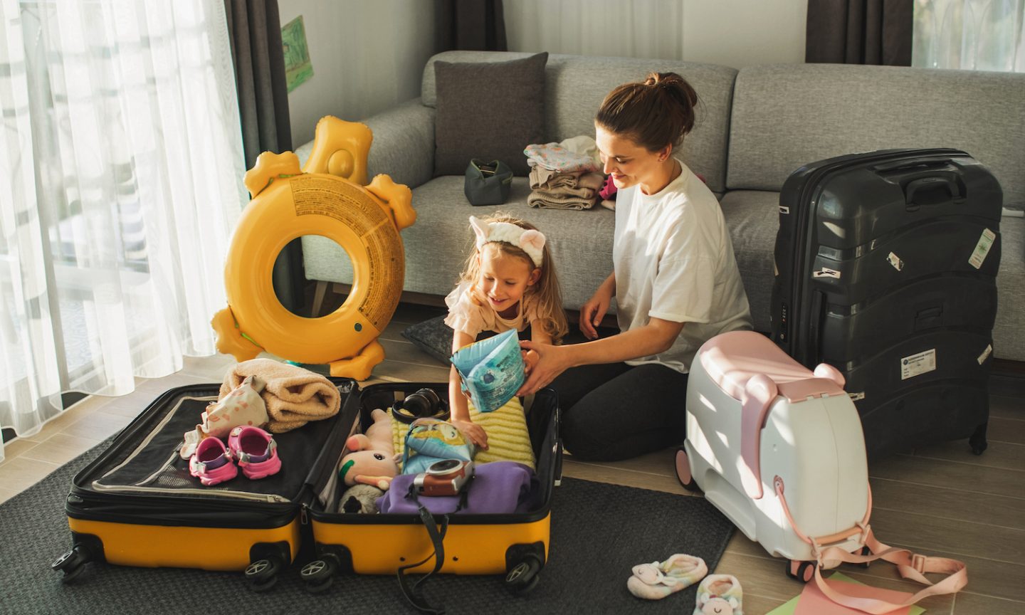 Children fishing net in trolley bag as vacation concept Stock