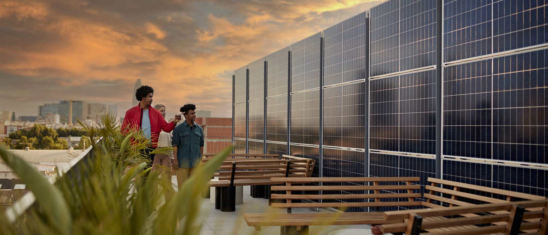 Friends discuss ESG investing on a rooftop with solar panels.