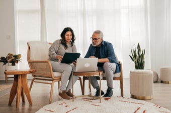 Couple comparing mortgage lenders in the living room.