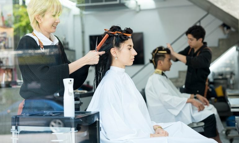 Hairdressers combing hair.