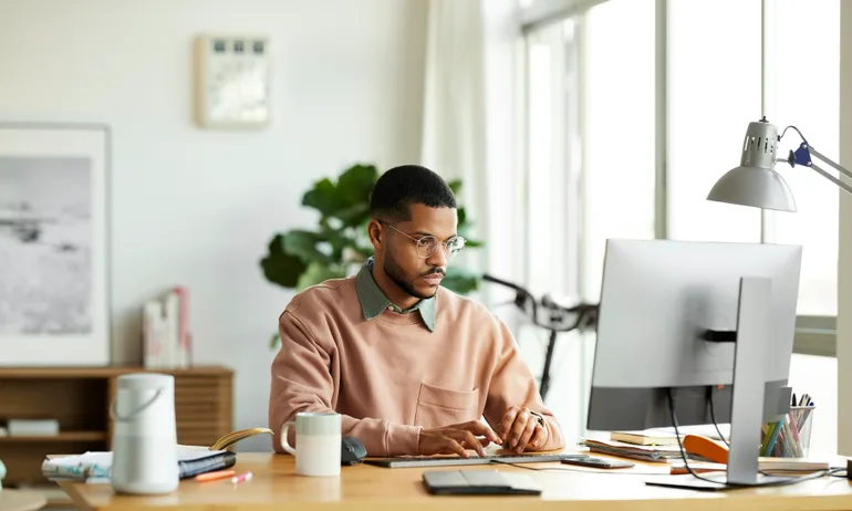 Freelancer Using Computer At Home Office