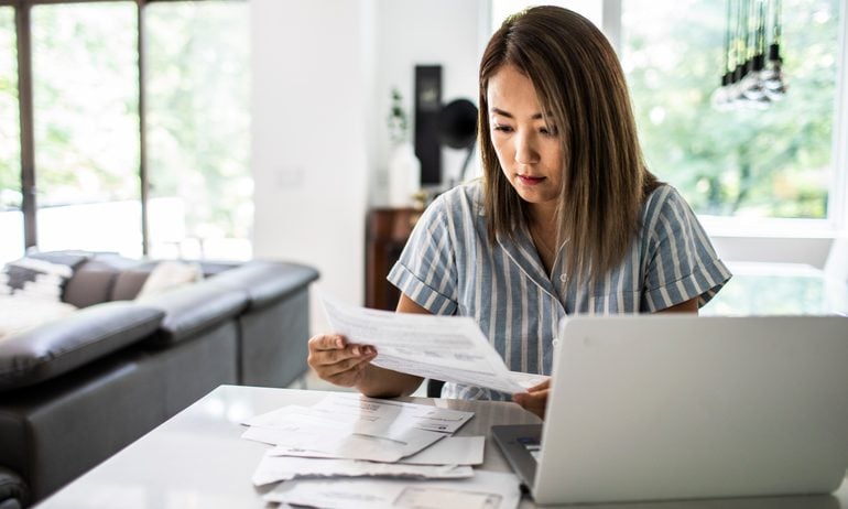 Woman paying bills at home