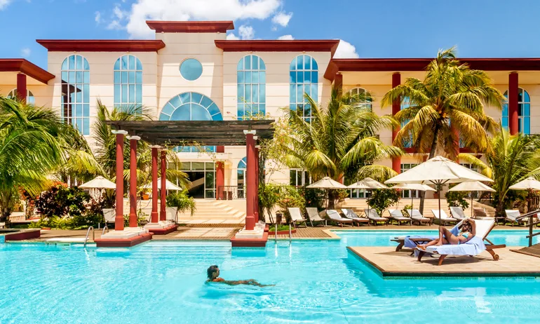 hyatt suite upgrade award being enjoyed by a woman in a resort pool