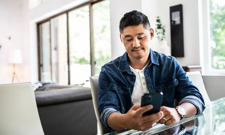 Man using mobile device at home