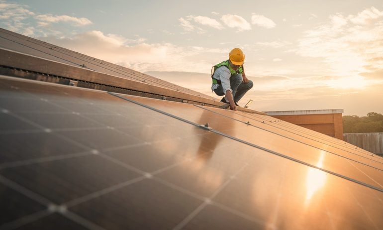 Engineer installing solar panel.