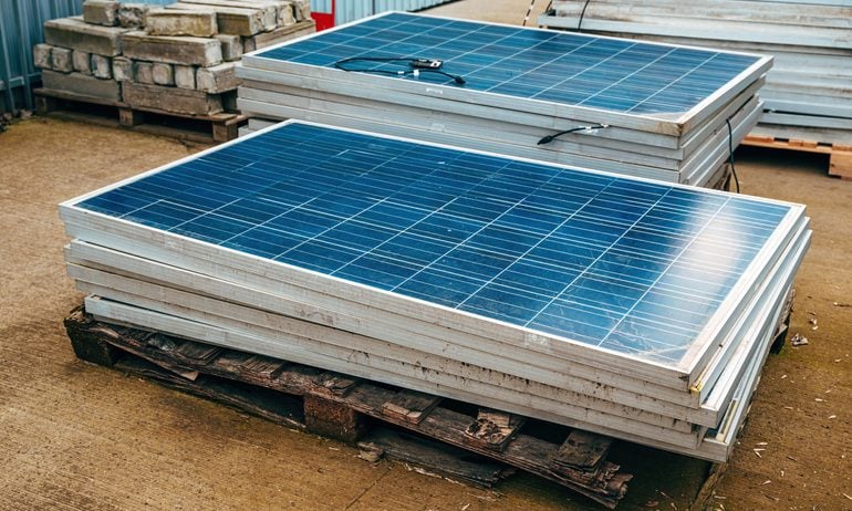 Old solar panels in factory yard.